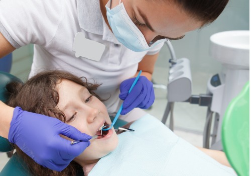 A child is seen during a dental exam. Associates in Dentistry is a Dentist in Canton IL.