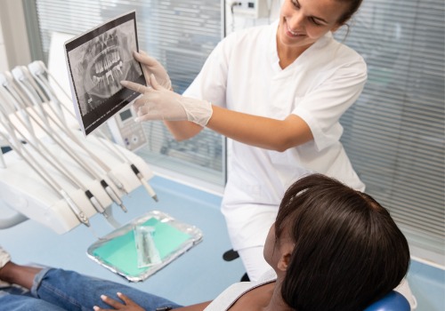 A patient is shown her dental x-rays. Associates In Dentistry is a Dentist Office Near You.