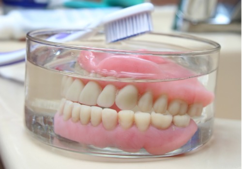 Dentures are seen soaking overnight. Associates In Dentistry offers dentures in Washington IL.