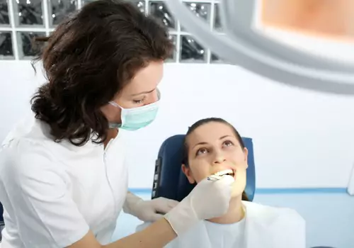 A woman is seen receiving dental services. Associates In Dentistry performs Restorative Dentistry.