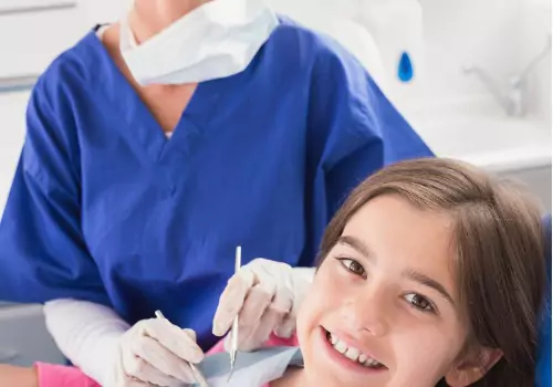 A girl is seen receiving dental care. Associates In Dentistry offers Emergency Dental Care in Elmwood IL.