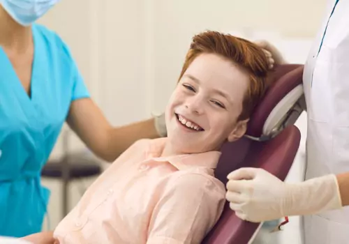 A boy is seen receiving dental care. Associates In Dentistry is a nearby dentist in Peoria IL.