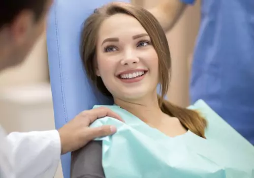 A woman is seen receiving dental care. Associates In Dentistry is a nearby dentist in Peoria IL.