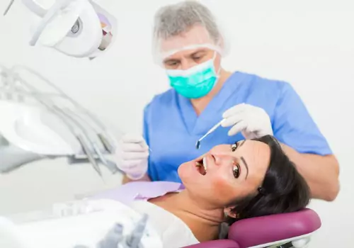 A woman is seen receiving a dental exam. Call Associates In Dentistry for a nearby dentist in Bartonville IL.