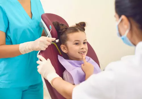 A child is seen receiving dental care.