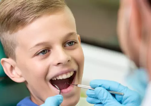 A boy is seen receiving dental care. Associates In Dentistry is a Family Dentist in Bartonville IL.