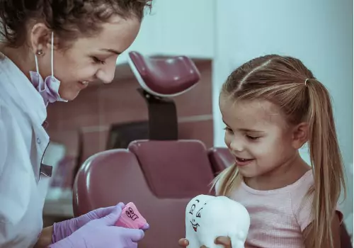 A young girl is seen receiving instruction at a dental office. Associates In Dentistry is a Family Dentist.