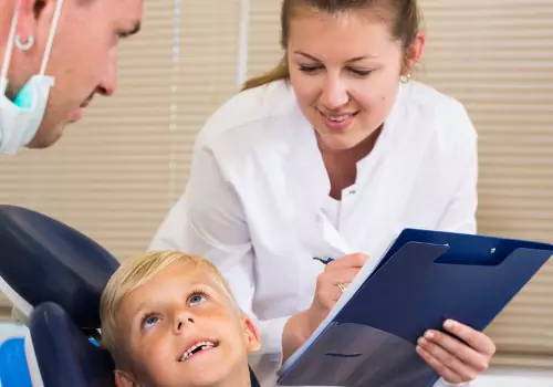 A child is seen at a dental office. Associates in Dentistry is a Family Dentist.