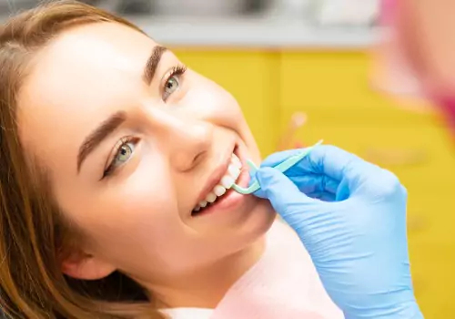 A patient is seen being flossed. Associates In Dentistry is a Local Dentist.