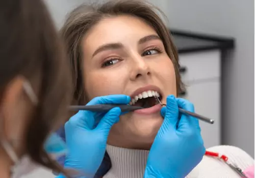 A patient is seen receiving a flossing. Associates In Dentistry is a Local Dentist.