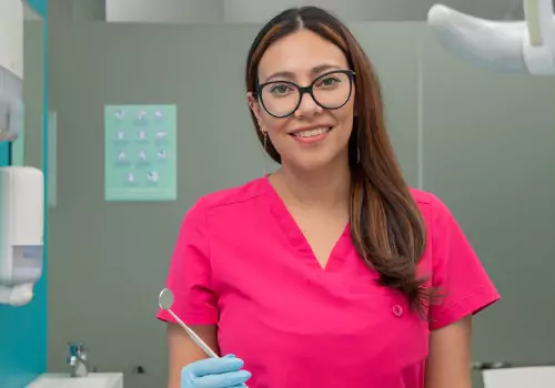 A dental worker is seen in a dental office. Associates In Dentistry is a Local Dentist.