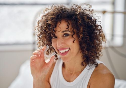 A patient is seen displaying her dental device. Associates In Dentistry is a dentist in central Illinois.