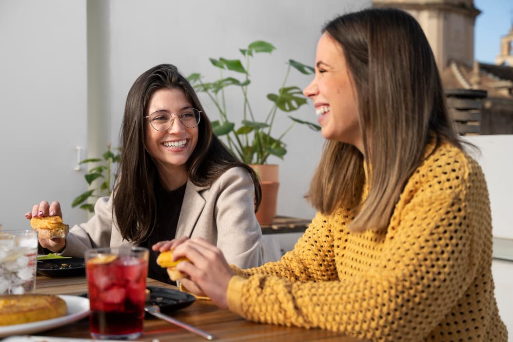 Confident patient in Canton, IL smiling while eating and talking comfortably, showing the functional benefits of a dental crown from Associates In Dentistry.