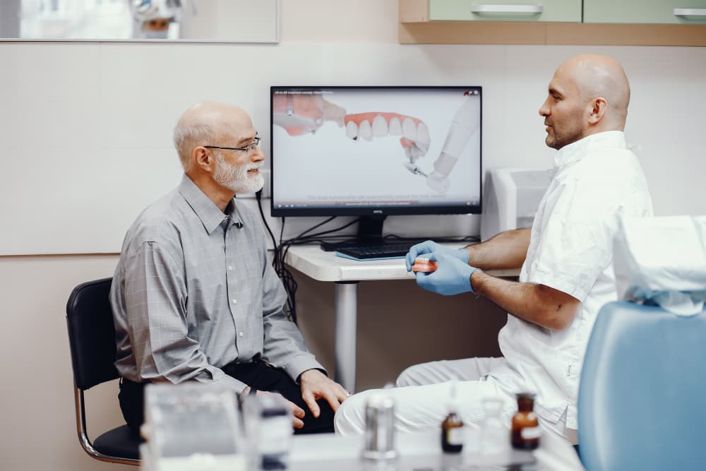 Patient and dental professional reviewing a personalized dental treatment plan on a screen at a Canton, IL dental office offering crowns, bridges, and cosmetic care.