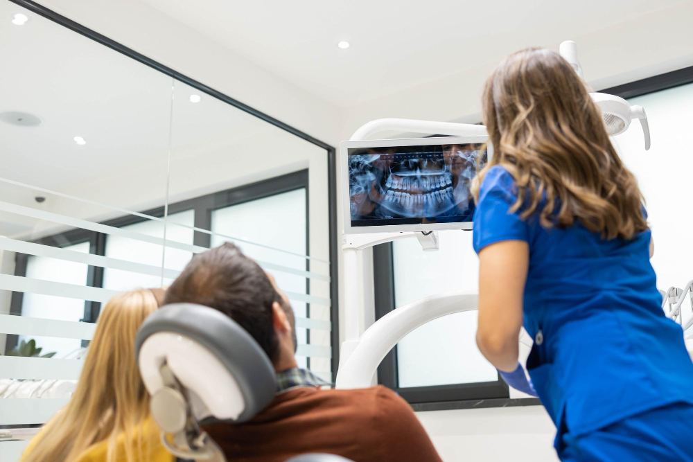 Dentist in Canton, IL discussing treatment options with adult patient using digital dental technology in a modern exam room.